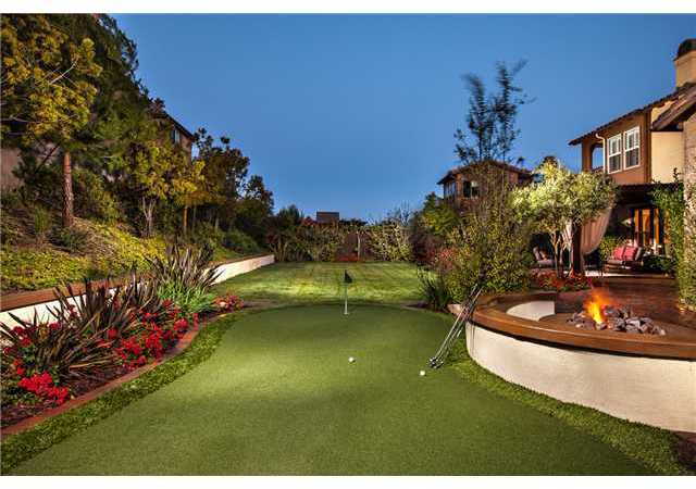 6989 Corte Langosta Carlsbad, CA 92009 - Photo 3 of 25 What is the saying..."Drive for show...putt for dough!" Your own private putting green to perfect your short game...does it get any better than this? Fire-ring next to the putting green w/ a seat wall + rear retaining wall at perfect seat height also.