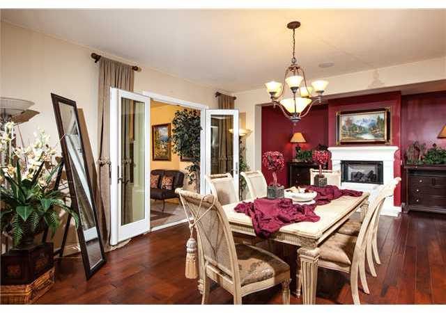 6989 Corte Langosta Carlsbad, CA 92009 - Photo 8 of 25 Amazing formal dining room can surely accomodate the most elaborate of dining tables, has a raised fireplace that can be appreciated from table height and double french doors to the entry courtyard for indoor/outdoor entertaining.