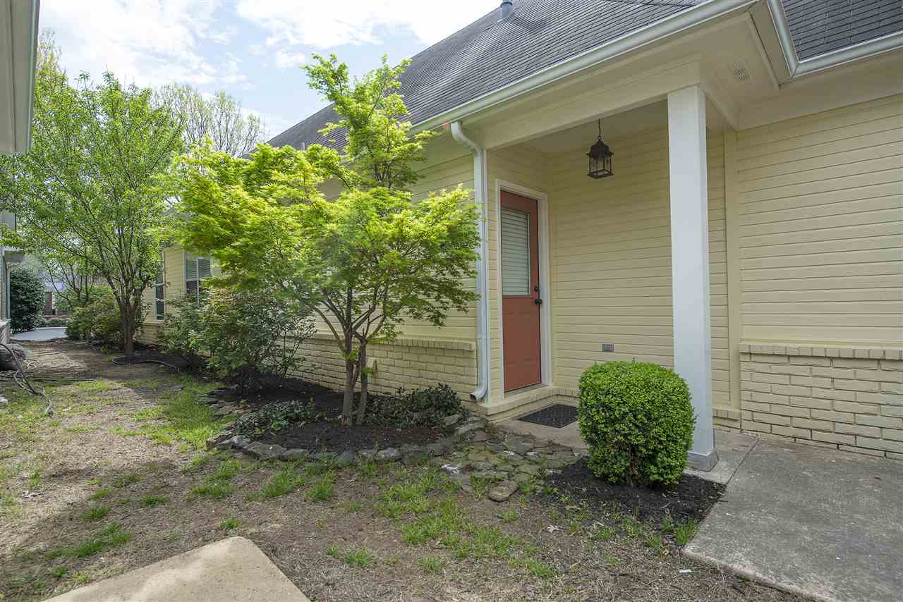 1237 Misty Isle Drive Memphis, TN 38103 - Photo 2 of 22 North side of the home and the rear covered patio and entrance. Notice the professional landscaping surrounds the home.