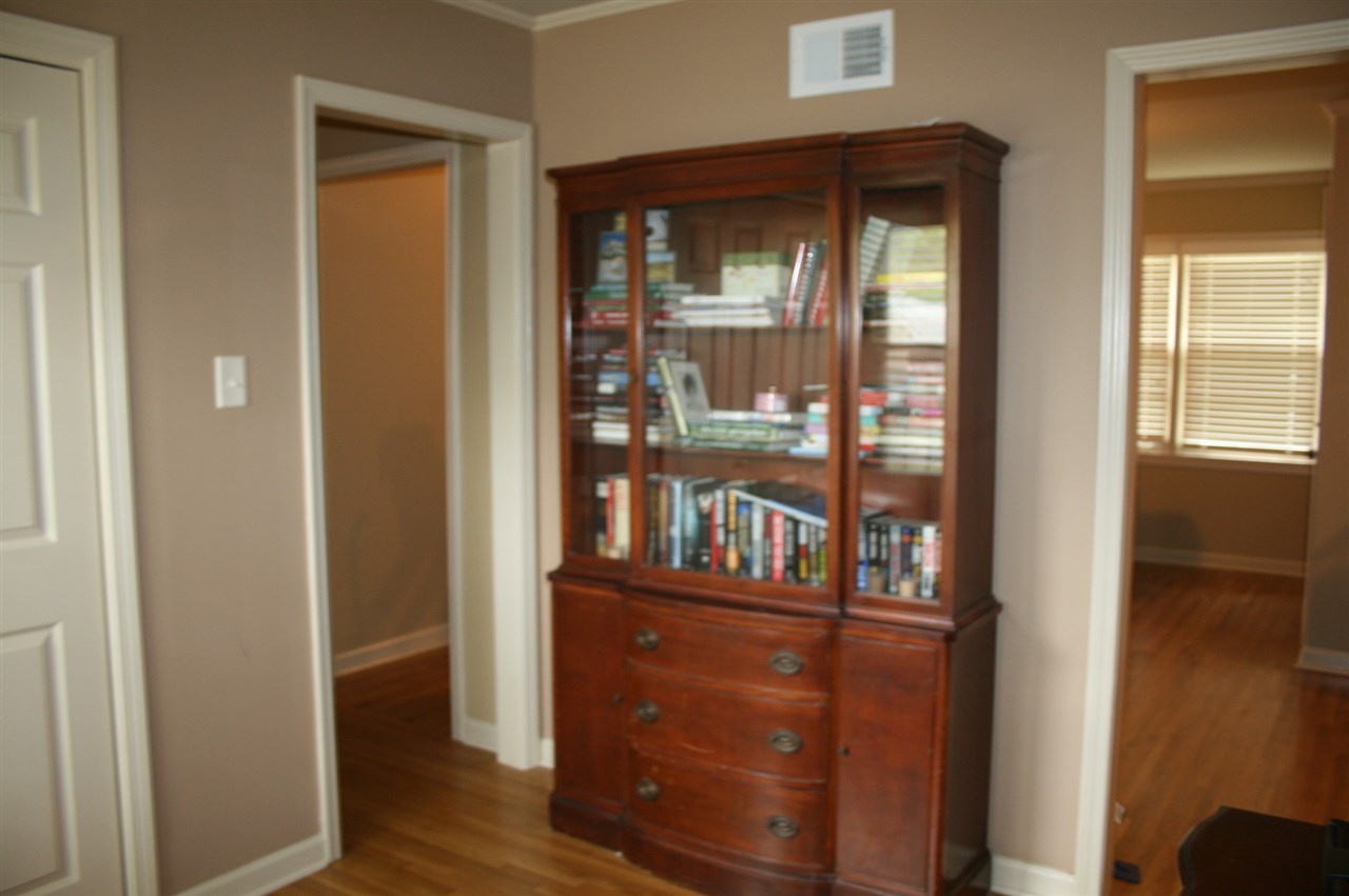 1015 Wilbec Road Memphis, TN 38117 - Photo 19 of 25 I see this "walk through" bedroom as a flex room. Could be the perfect office, craft room, etc. The two windows behind me look like there could French doors here. Which if you did that, would lead straight out too the deck & your future pergola. ;-)