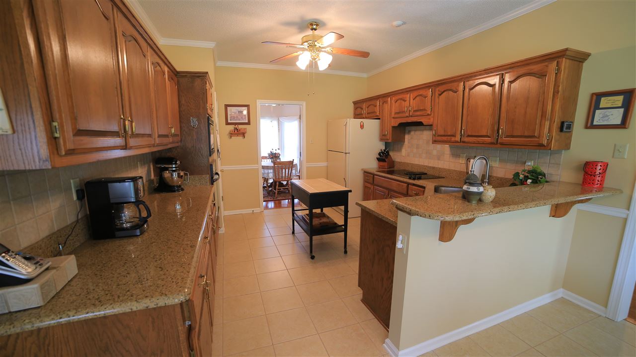 4245 High Plains Road Bartlett, TN 38135 - Photo 6 of 25 Solid surface counters, tile backsplash, and Breakfast Bar.