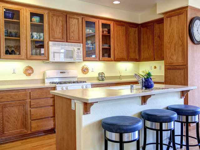 2250 Historic Decatur Road, Unit 84 San Diego, CA 92106 - Photo 9 of 25 Kitchen with Large Island and Glass Insert Cabinets