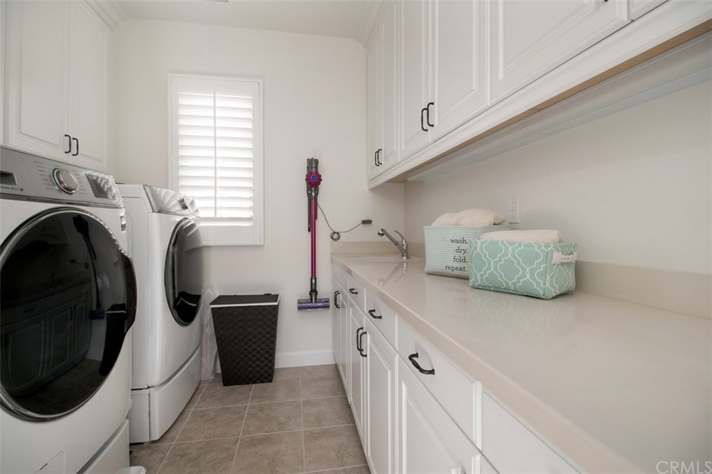 17 Rawhide Irvine, CA 92602 - Photo 28 of 56 Laundry room with upgraded tile flooring and caesarstone countertops