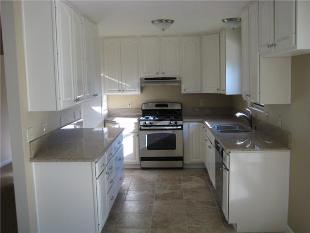 New granite counters and tiled flooring in kitchen and dining..