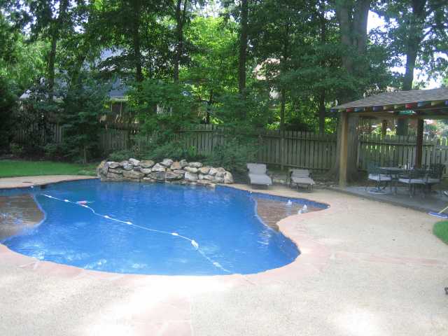 2170 Cordes Road Germantown, TN 38139 - Photo 7 of 9 Relax All Year Around in the Heated Gunite Pool. The Pool Features a Rock Waterfall and Other Water Features that can be Controlled by a Remote. This Large Backyard has a Covered Cabana that is Great for Poolside Entertaining.