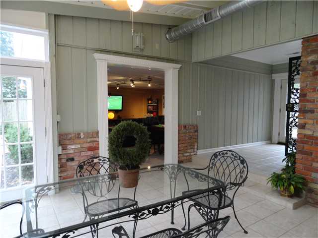 4341 Burgundy Road Memphis, TN 38111 - Photo 9 of 12 A view of the sunroom coming from the den. It opens into the media/gameroom and leads to pool area. To the right are doorways leading to the kitchen and to the carport.