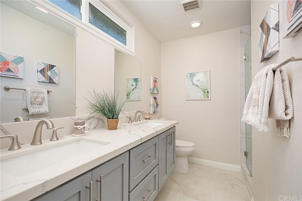 1745 North Bates Circle Anaheim, CA 92806 - Photo 16 of 32 En suite master bathroom with dual sinks, quartz counters, and shaker cabinetry