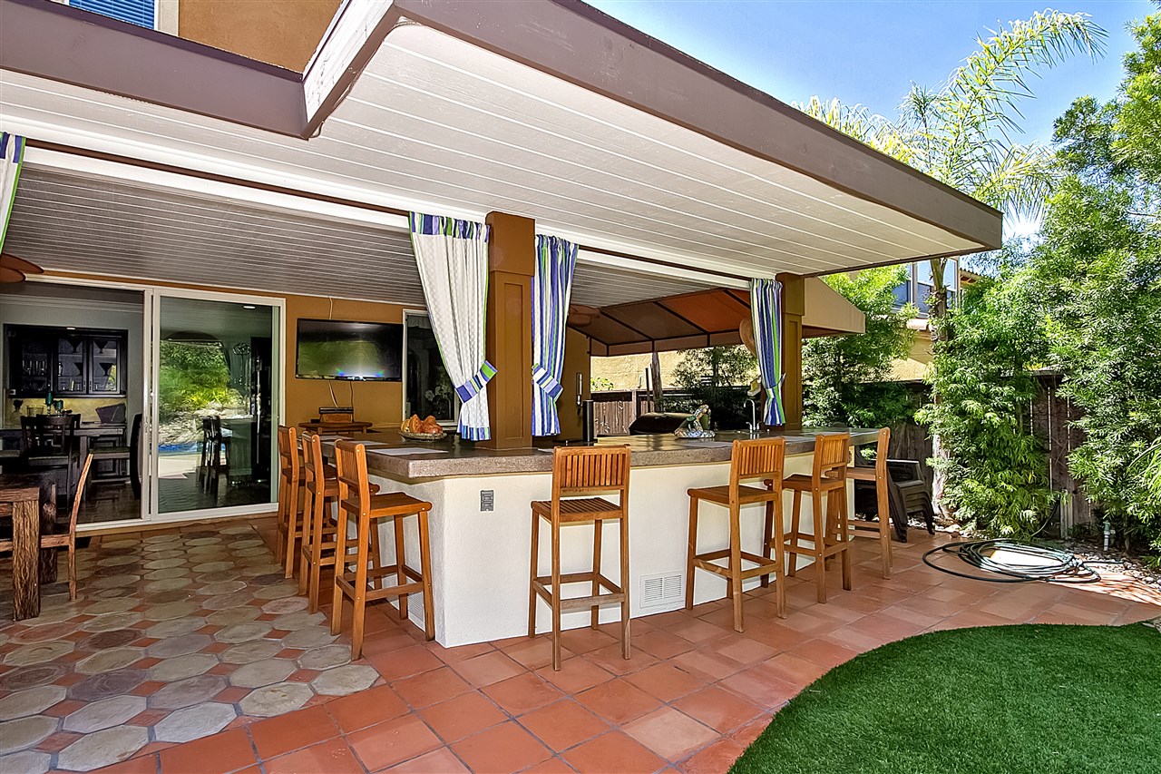 1853 Shadetree Drive San Marcos, CA 92078 - Photo 24 of 25 Complete outdoor Kitchen with built in BBQ, Refrigerator, Kegorater, Storage. Huge Counter entertaining area with custom Concrete countertops and seating for up to eight or more people.