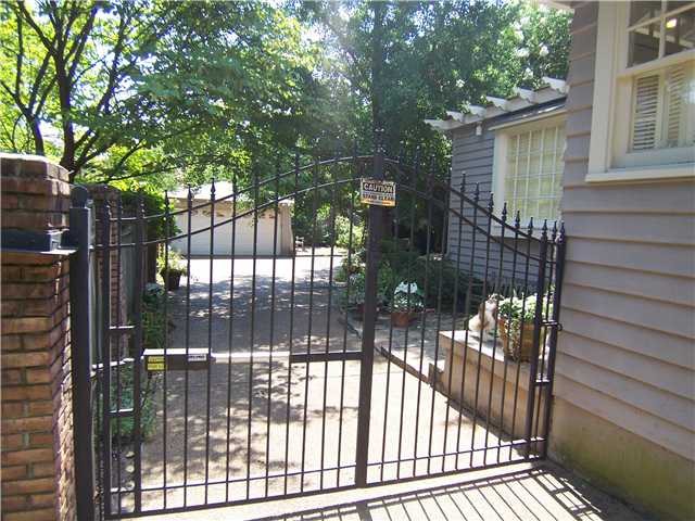 660 Rozelle Street Memphis, TN 38104 - Photo 10 of 12 Remote controlled gate for security and dog or child safety. @ car garage beyond...Gardens are to the right behind the house.