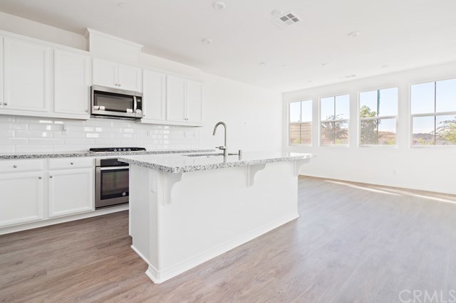 108 Natal Road Rancho Mission Viejo, CA 92694 - Photo 1 of 1 Stunning kitchen featuring granite counters with subway tiled backsplash.