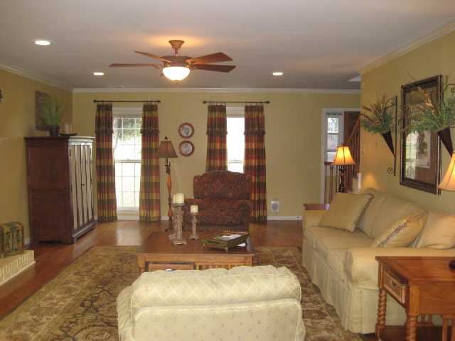 2435 Howard Road Germantown, TN 38138 - Photo 5 of 10 Tastefully decorated great room features many windows which light the room with both morning and afternoon sun. Smooth ceilings with recessed lights, wood floors, crown molding and a wood burning fire place.