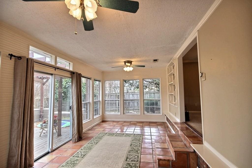 Bright sunroom overlooks backyard with deck and pool (can stay or go :)