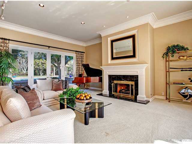17036 Circa Del Sur Rancho Santa Fe, CA 92067 - Photo 2 of 25 The spacious formal living room is trimmed with crown and base moldings, custom paint and French doors leading to an outdoor patio and onto the grounds beyond.