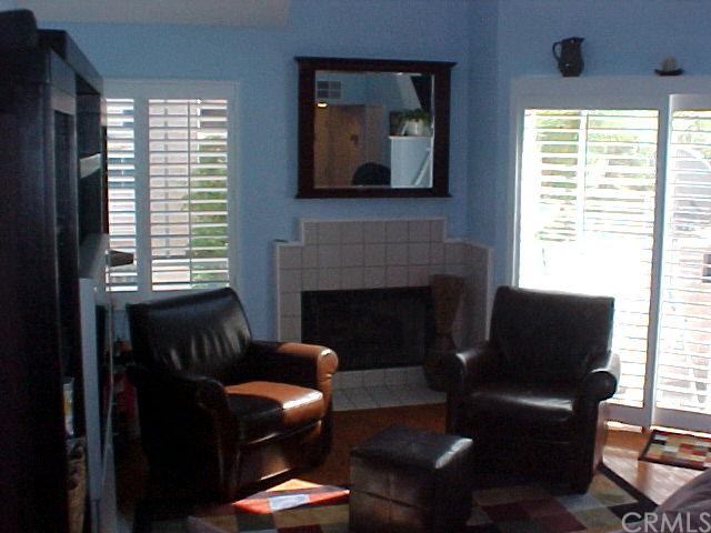 Elegant living room w/ wood floors and plantation shutters.