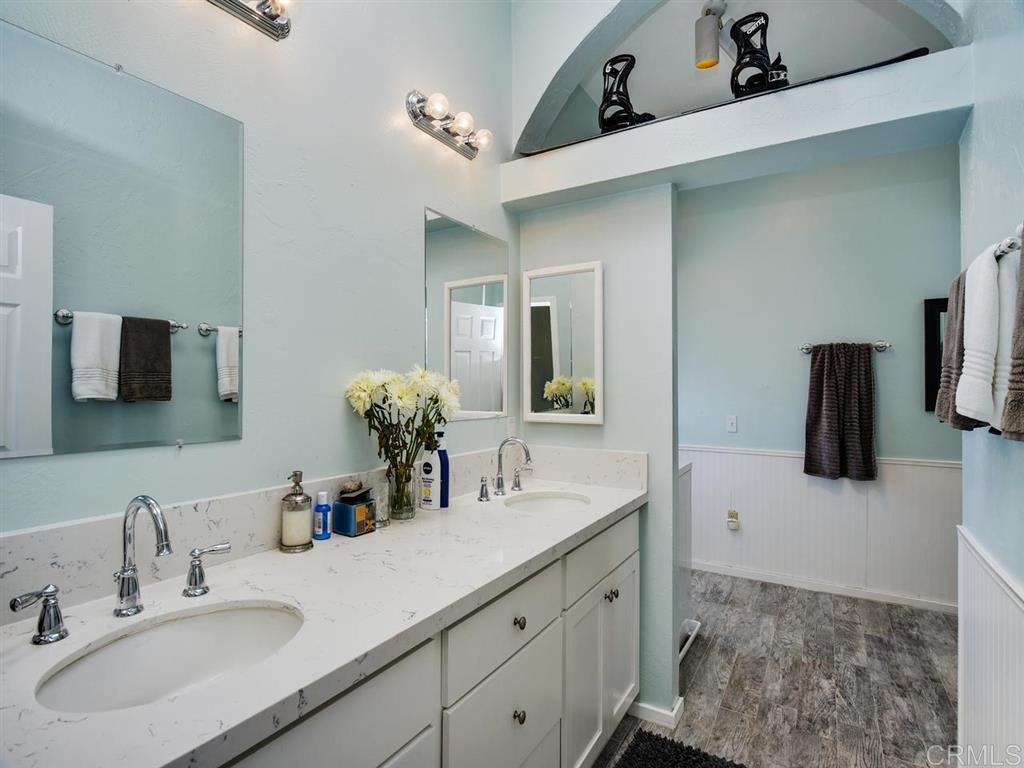 869 Beryl Street San Diego, CA 92109 - Photo 11 of 25 Master bathroom has new dual-sink vanity, walk in shower, separate water closet, and side-by-side laundry.