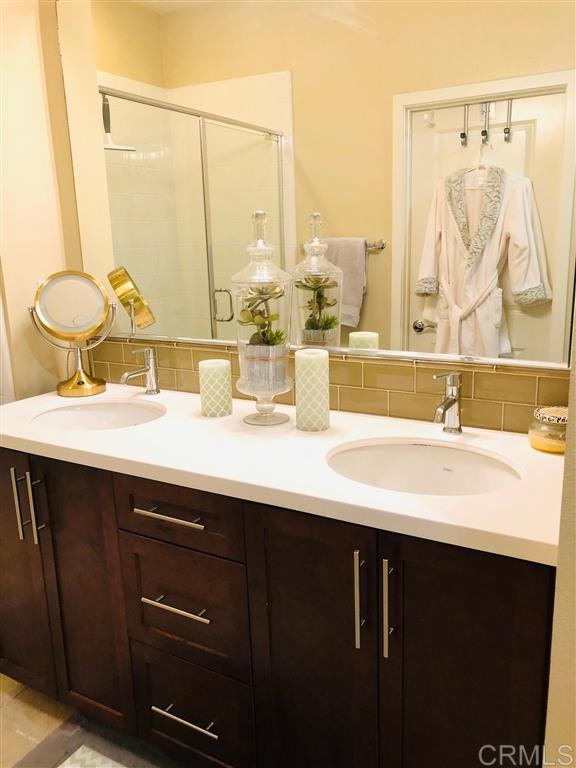 17 Alzada Street Rancho Mission Viejo, CA 92694 - Photo 11 of 20 Ensuite bathroom complete w/ walkin closet, dual sinks, stained shaker cabinets and chrome accented fixtures