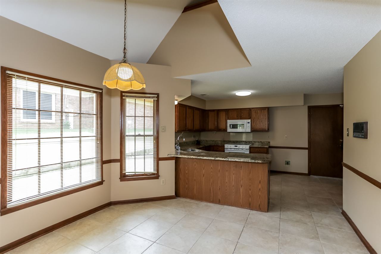 8516 Buckhurst Road Memphis, TN 38016 - Photo 10 of 25 Wonderful eat in kitchen with counter and cabinet space galore! Beautiful granite countertops, sturdy tile floor, and a full complement of appliances.
