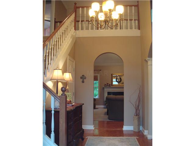 Beautiful two story entry with arches to great room and formal dining room.