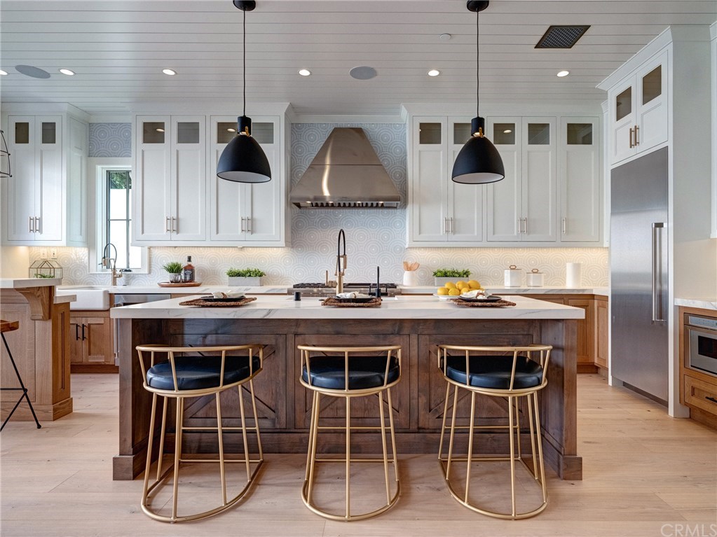 559 31st Street Manhattan Beach, CA 90266 - Photo 6 of 49 Neolith stone counters, Thermador professional series appliances, dual sinks, additional beverage fridge, Brizo faucets, breakfast counter, indoor/outdoor bar & entertainment area.