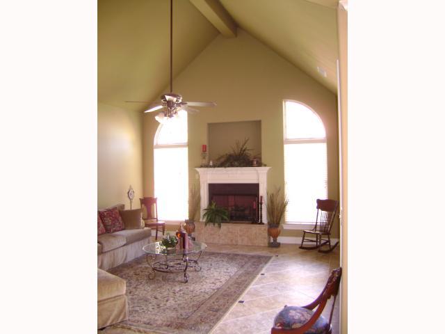 156 Colton Ridge Lane Atoka, TN 38004 - Photo 4 of 6 Cozy hearth room with large built-in niche for TV, high ceilings, tile flooring + double wood doors leading to back patio area!
