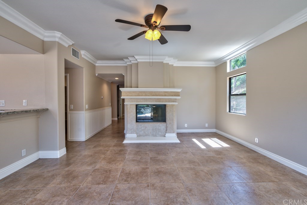3086 Diamondview Circle Corona, CA 92882 - Photo 11 of 66 With a massive fireplace as the focal point, the cozy family room features crown moldings and oversized tile floors that expand throughout the first level.