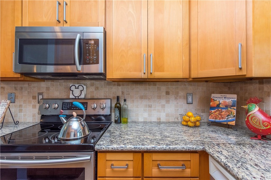131 Remington, Unit 239 Irvine, CA 92620 - Photo 15 of 36 The custom marble backsplash is a complement to the rich granite counters!