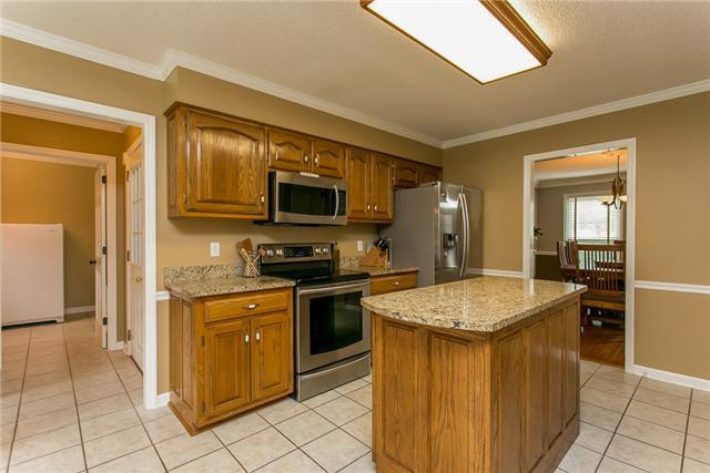 1116 Abbey Road Columbia, TN 38401 - Photo 10 of 30 Kitchen with granite countertops, pantry, stainless appliances, island, and tile floor.