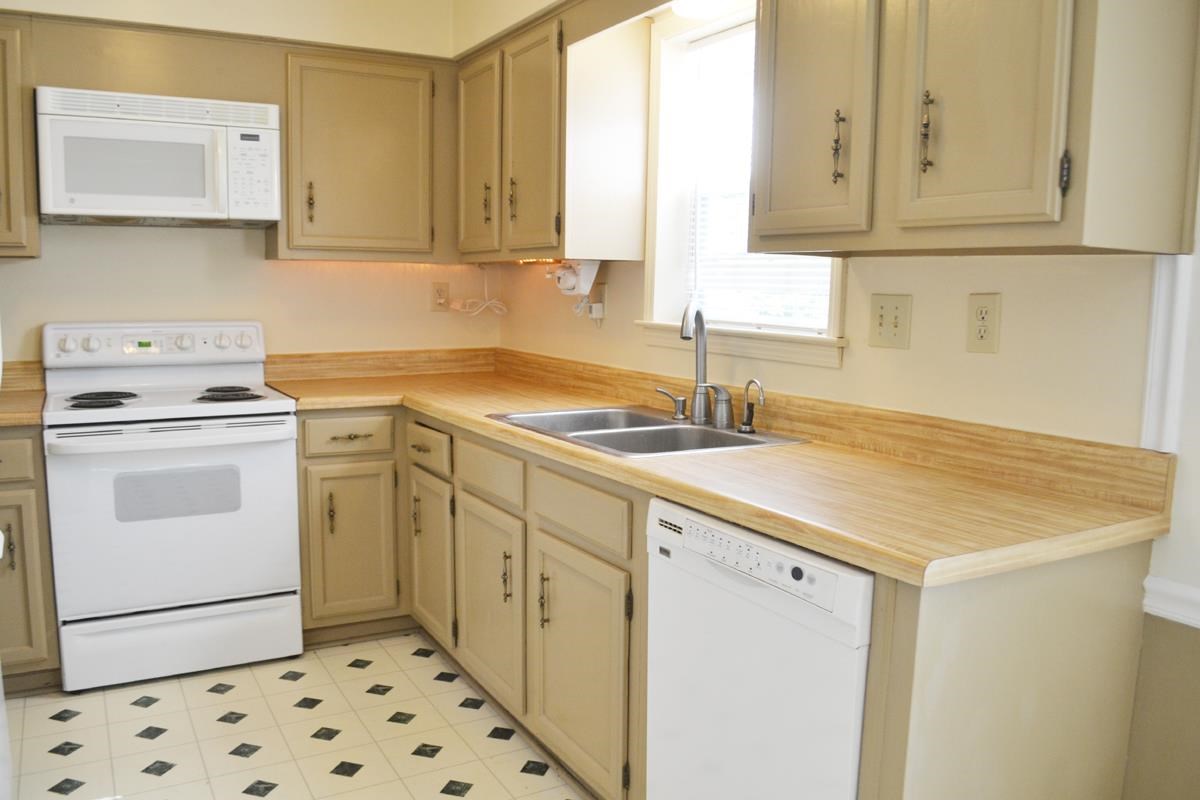 3321 Bright Ridge Cove Memphis, TN 38115 - Photo 2 of 11 Open and bright kitchen that features updated appliances, painted cabinets, over-sized window, eat in breakfast area, and a breakfast bar.