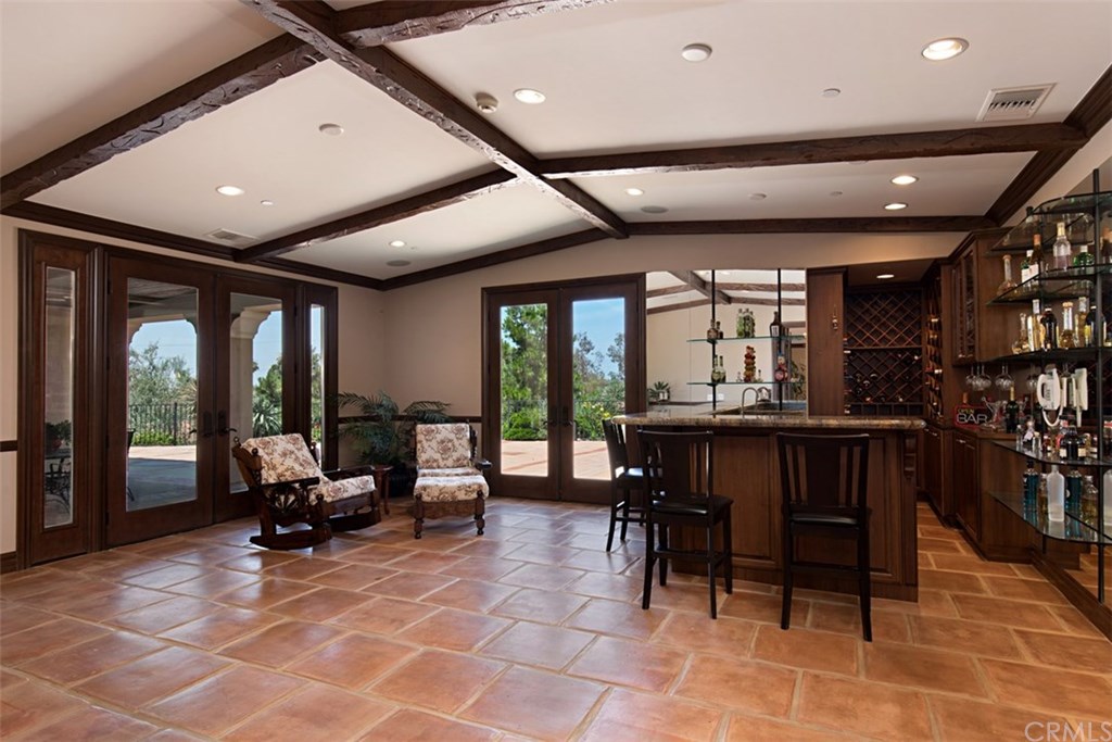 1640 Hillside Avenue Norco, CA 92860 - Photo 19 of 75 Main entertainment room with two sets of French doors, bar area and wine alcove
