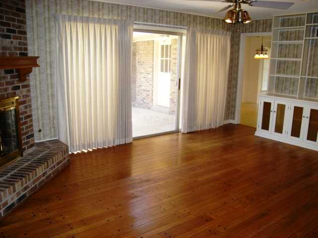 6418 Messick Road Memphis, TN 38119 - Photo 5 of 11 19x14 Den with Corner Gas Starter Fireplace with Gas Logs (also wood-burning), Pegboard Hardwood Floor, Built-In Bookcases, and Glass Door to Patio and Rear Yard