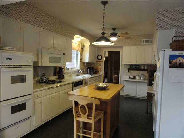 3014 Sycamore View Road Bartlett, TN 38134 - Photo 6 of 12 Gas cooking, two ovens,microwave, center island, good counter space, ceiling fan, updated lighting and ample storage are attractive features of the kitchen. Laundry appliances(not here) also stay w house. Large adjacent eating space in next picture.