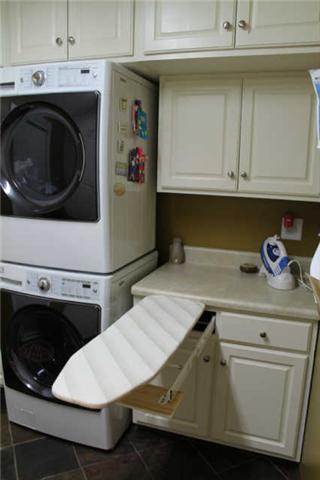 3034 New Hall Road Greenbrier, TN 37073 - Photo 8 of 30 Tiled laundry room with floor to ceiling storage. All shelves in the pantry pull out, hide away ironing board, folding table, space to hang dry clothes and room for a chest freezer. This is a dream of a laundry room/walk in pantry