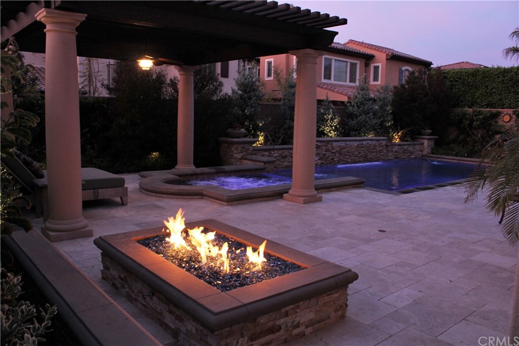 17 Rawhide Irvine, CA 92602 - Photo 35 of 56 Top of the line salt water pool features large waterfall, LED lights, connected jacuzzi spa covered by outdoor structure. High end equipment (Pentair and Jandy) with mobile app control of pool features. Cost of private luxury is kept low with 12-panel 3.7 kilowatt solar power ($125 average electric bill including heating and use of pool features).