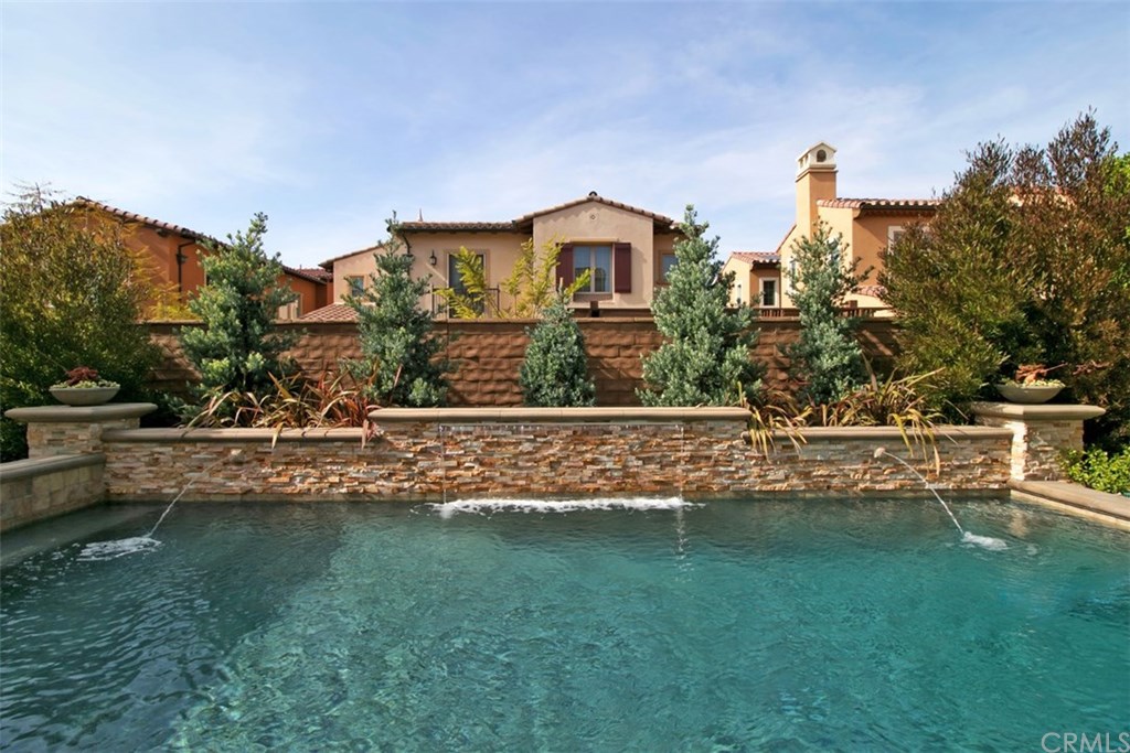 17 Rawhide Irvine, CA 92602 - Photo 33 of 56 Top of the line salt water pool features large waterfall, LED lights, connected jacuzzi spa covered by outdoor structure. High end equipment (Pentair and Jandy) with mobile app control of pool features. Cost of private luxury is kept low with 12-panel 3.7 kilowatt solar power ($125 average electric bill including heating and use of pool features).