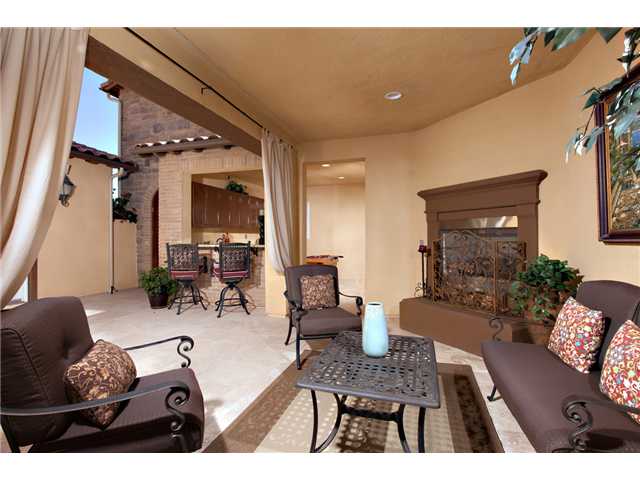 6989 Corte Langosta Carlsbad, CA 92009 - Photo 6 of 25 Snuggle up next to your own outdoor fireplace for some R & R in the courtyard. A wonderful place to sit and read a book or write.