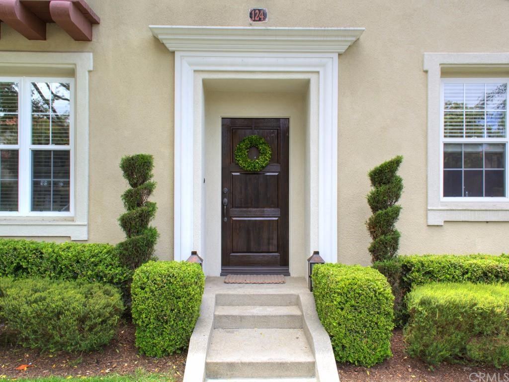 124 White Flower Irvine, CA 92603 - Photo 2 of 26 Elegant dark wood front door and exceptional landscaping with a Tuscan Inspiration