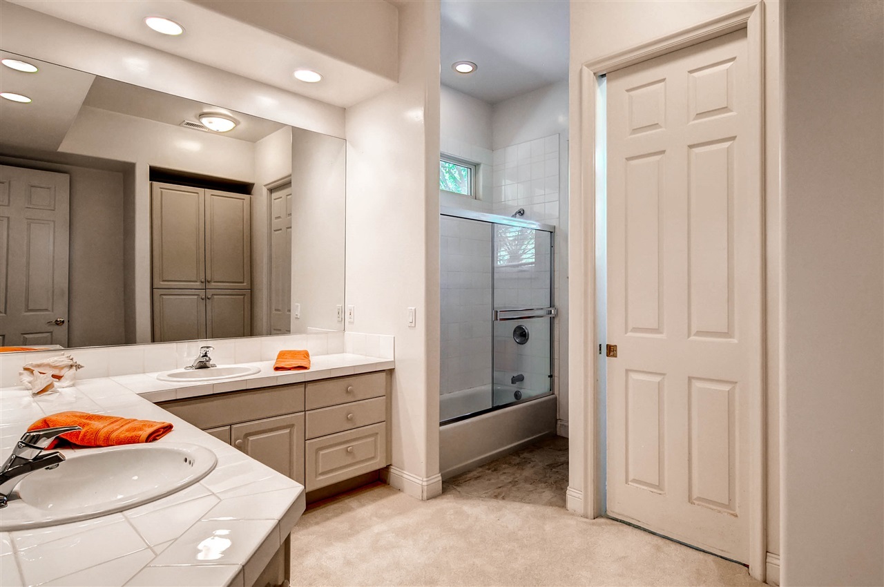 14888 Las Mananas Rancho Santa Fe, CA 92067 - Photo 24 of 25 This bathroom is next to a secondary bedroom and features dual sinks, shower/tub, and a separate water closet.