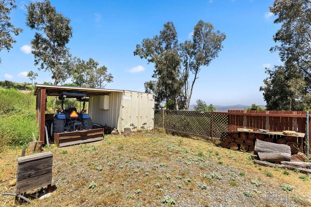 19259 Rangeland Road Ramona, CA 92065 - Photo 22 of 25 Tractor and storage area