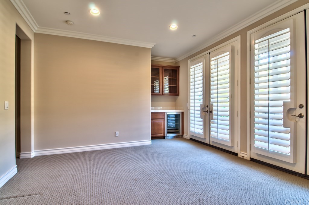 2148 Sageleaf Circle Corona, CA 92882 - Photo 29 of 74 The game/bonus room features a wet back with a wine fridge and 3 sets of French doors that lead to 2 balconies to enjoy the views and to expand the living areas during special gatherings.