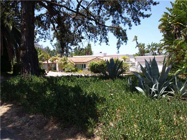 1378 Crest Drive Encinitas, CA 92024 - Photo 1 of 16 Front of house has circular european rock gravel driveway, fountain, and gorgeous mature landscaping