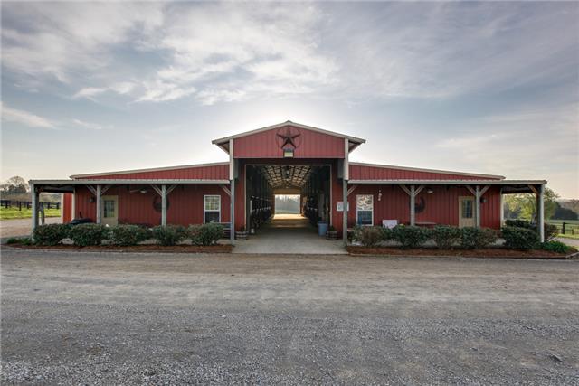 13920 Patterson Road College Grove, TN 37046 - Photo 3 of 30 14 stall barn w/2 tack rooms, feed room, lounge, full bath, workshop, equipment storage, 6 horse grooming station, wide hallways, hot/cold wash rack, plus 4 more wash stations under roof.