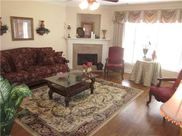 631 Hawks Peaks Road Collierville, TN 38017 - Photo 3 of 17 Formal living room with fireplace and gorgeous hardwood floors. this home boasts a tremendous amount of natural light for tons of windows throughout