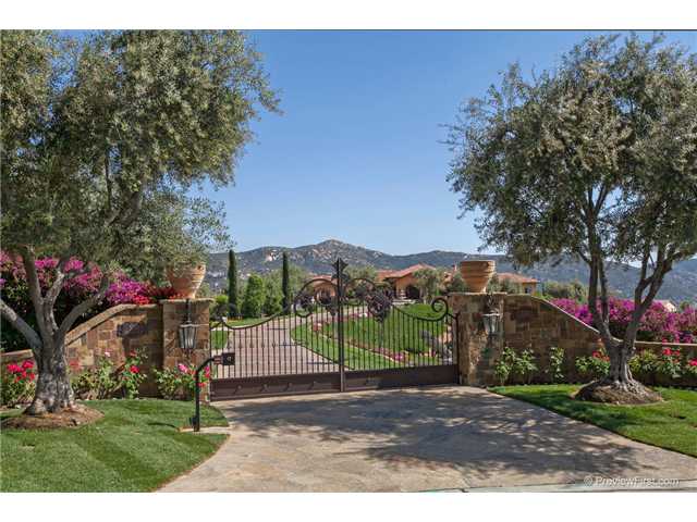 BEHIND THESE GATES SIT TWO GORGEOUS HOMES ON TWO SEPERATE PARCELS EACH HOME HAS AN OVERSIZED FOUR CAR GARAGE . GUEST HOUSE GARAGE IS A FOUR CAR AND RV GARAGE, FEATURING STEEL POWDER COATED DRAWERS, CABINETS, AND POLISHED STAINLESS STEEL TOPS.