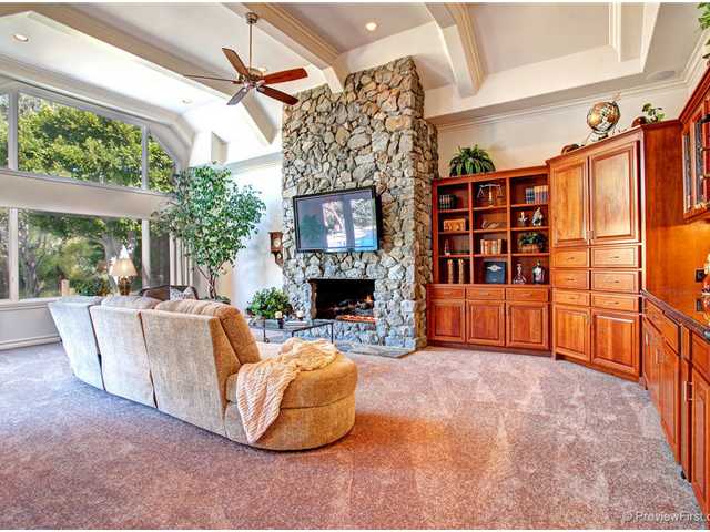 17036 Circa Del Sur Rancho Santa Fe, CA 92067 - Photo 5 of 25 The very spacious family room with its beautiful bulit-ins, Scotsman ice maker, custom ceiling treatment & masonry fireplace has views of the park-like yard & pool area.