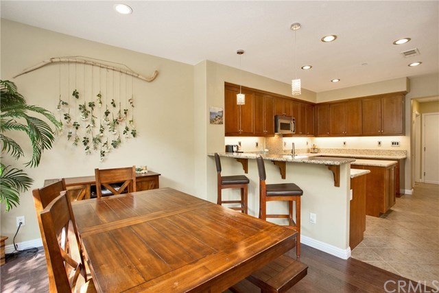 21 Corte Javier San Clemente, CA 92673 - Photo 5 of 30 The dining room is open to the kitchen and family room and features gorgeous hardwood flooring.