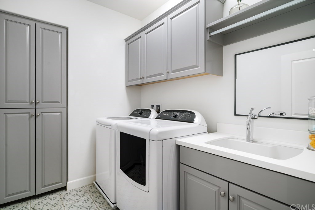 116 Mosswood Irvine, CA 92620 - Photo 29 of 42 The laundry room is conveniently located upstairs and features lots of storage, ornate tile flooring, and large sink with pull-out faucet for easy cleaning.