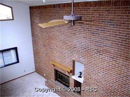 4821 Chaparral Road Colorado Springs, CO 80917 - Photo 4 of 13 Full 2 story brick throm wall in greatroom.