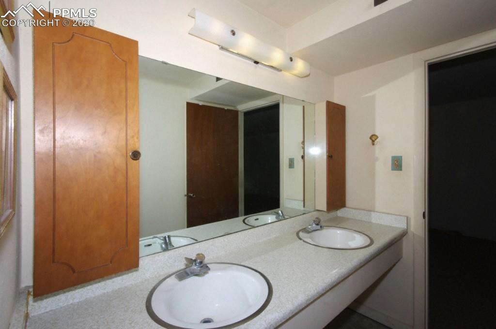 1414 Prairie Road Colorado Springs, CO 80909 - Photo 19 of 24 Basement Full Bath with Double Vanity