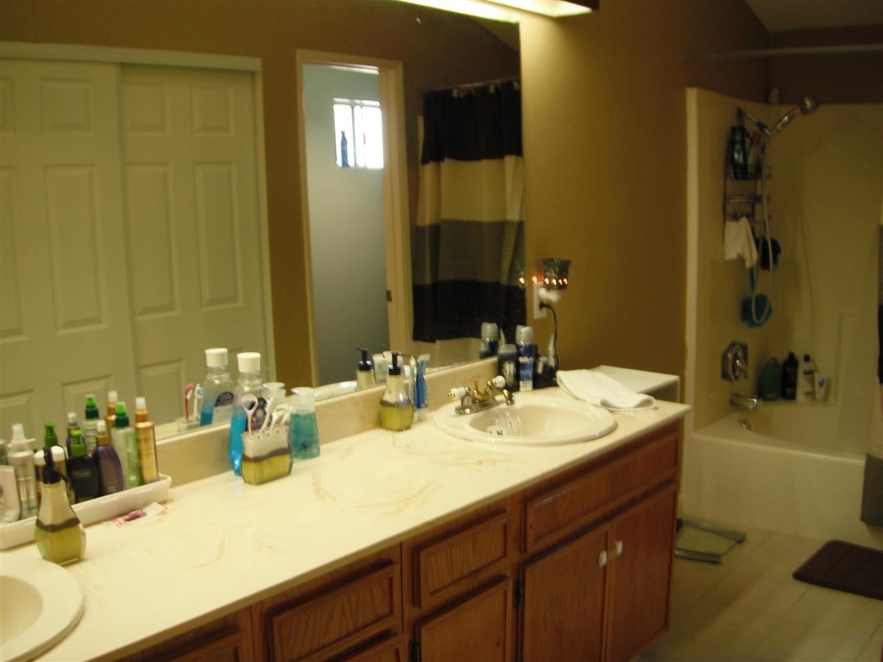 Master bathroom has double sinks, oval bathtub, separate "water closet" and houses the 2nd set of closets for the master bedroom.