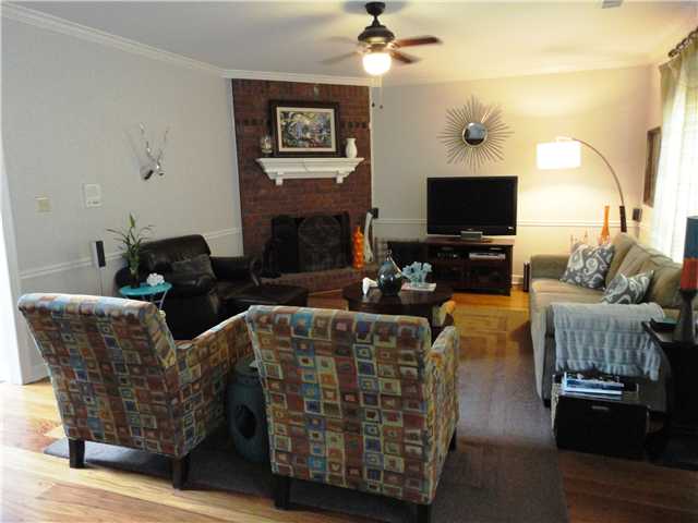 8736 Raspberry Lane Memphis, TN 38016 - Photo 7 of 25 Large Great Room with Brick Fireplace NOTE: The Blinds Stay. The Curtains & Rods Do Not Stay. TVs & Speakers Do Not Stay Either.